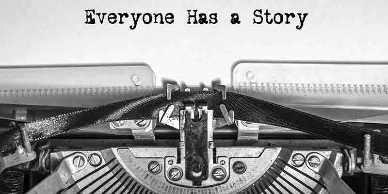 Everyone Has a Story printed on a sheet of paper on a vintage ty